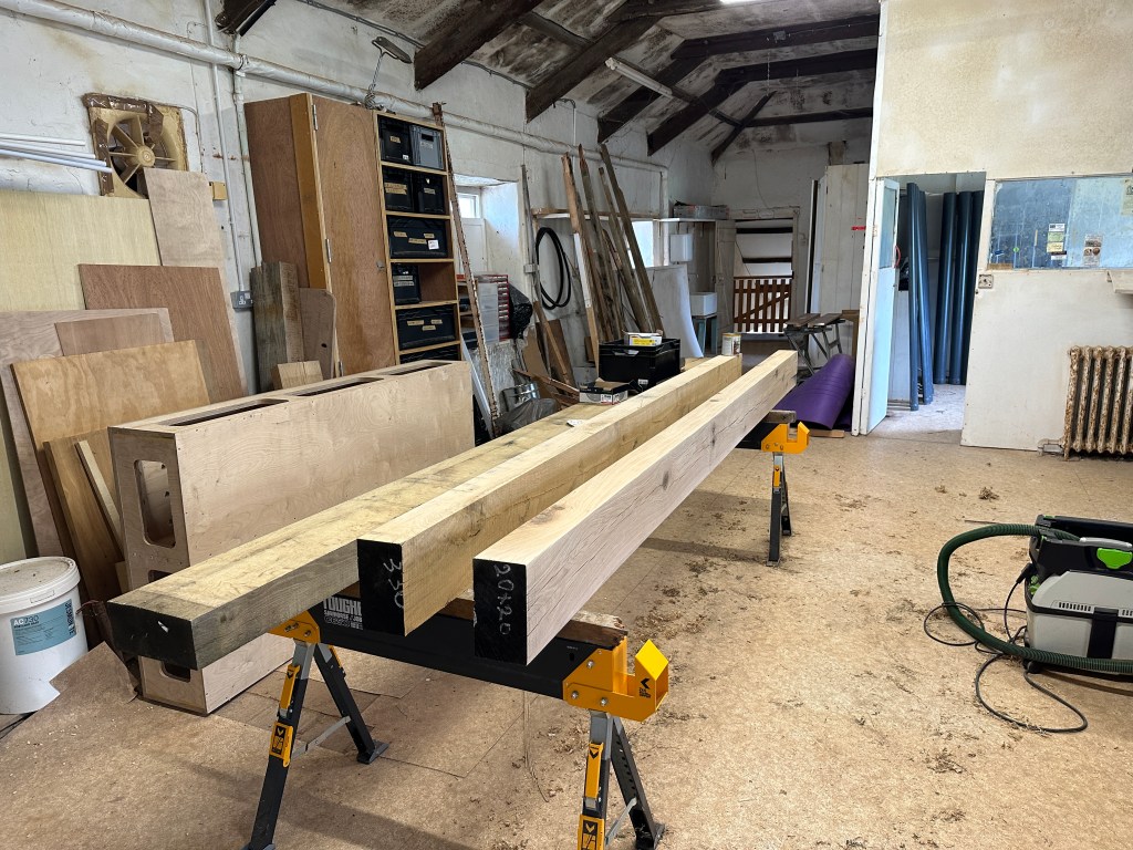New oak beams being prepared for roofing work