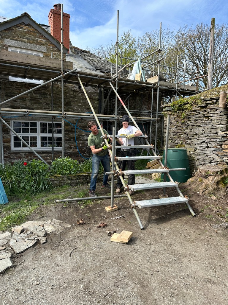 Special scaffolding steps being erected to enable roofers to carry heavy loads up and down to the roof.