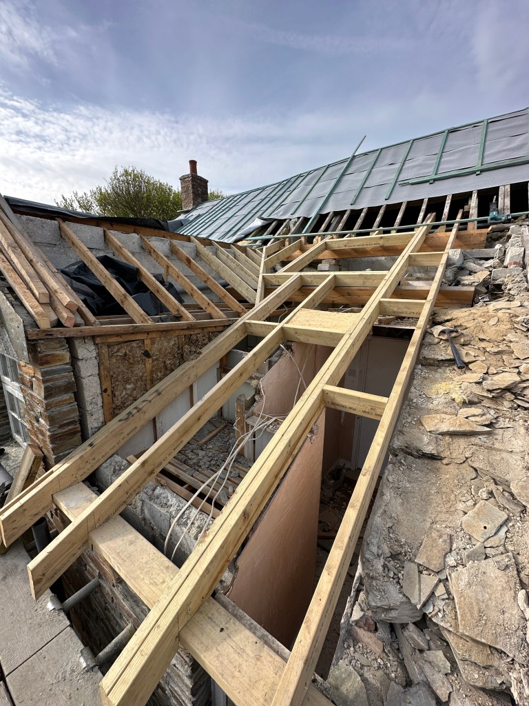New timber structure designed to support roof slates and a conservation grade skylight.
